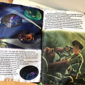 May include: A children's storybook open to pages five and six, featuring colorful illustrations of Toy Story characters including Woody, Buzz Lightyear, and Mr. Potato Head. The pages contain printed English text narrating a scene at a garbage dump.