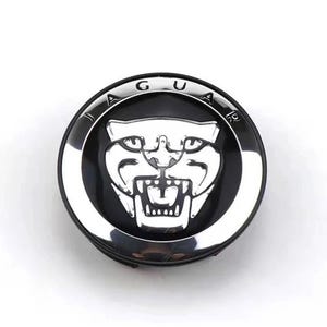 Może przedstawiać: Czarny i srebrny emblemat Jaguara. Emblemat przedstawia srebrną głowę jaguara pośrodku, otoczoną czarnym tłem. Słowo "JAGUAR" jest napisane w kolorze srebrnym na zewnętrznej krawędzi emblematu.