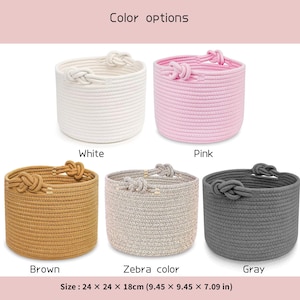 May include: A collection of five round rope baskets in various colors: white, pink, brown, zebra print, and gray. Each basket has a knotted rope detail on the rim. The dimensions are 9.45 x 9.45 x 7.09 inches.