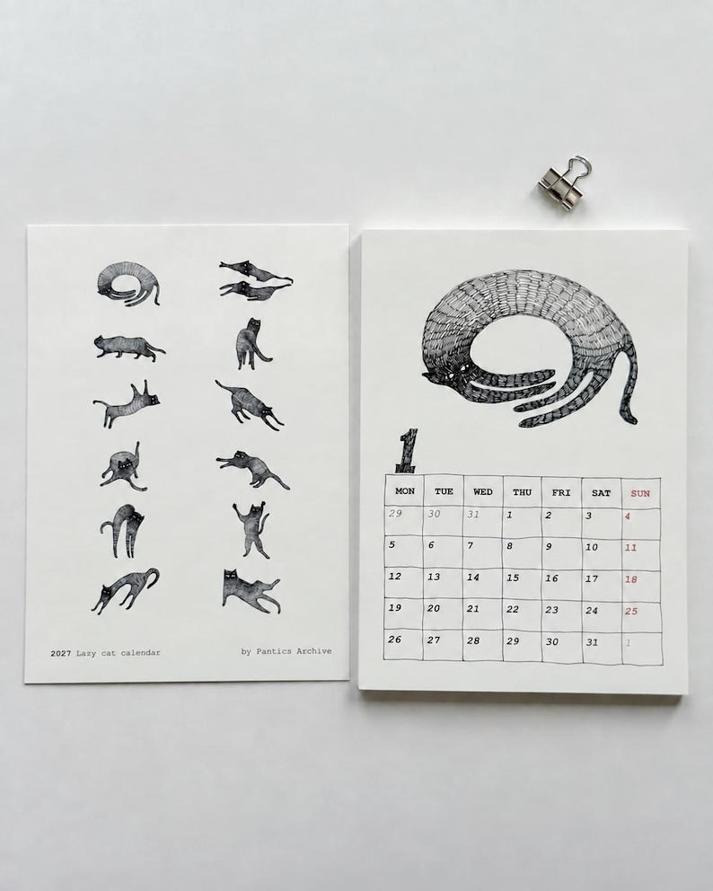 May include: A 2027 Lazy cat calendar by Pantics Archive featuring two white pages. The left page displays small black and white cat illustrations. The right page shows a large cat drawing above a monthly grid for January with the number 1.