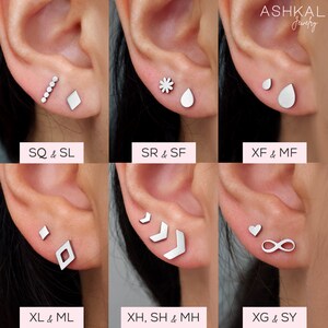 Puede incluir: Seis pares diferentes de pendientes de plata, cada par con un dise&ntilde;o &uacute;nico. Los pendientes se muestran en los l&oacute;bulos de las orejas de una modelo. Los dise&ntilde;os incluyen una fila de peque&ntilde;os c&iacute;rculos, un diamante, una flor, una l&aacute;grima, un c&iacute;rculo peque&ntilde;o, una l&aacute;grima m&aacute;s grande, un diamante, un chevron, un coraz&oacute;n y un s&iacute;mbolo de infinito.