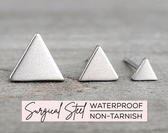 May include: Three silver triangle stud earrings of different sizes. The earrings are made of surgical steel and are waterproof and non-tarnish.