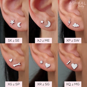 Puede incluir: Seis pares de pendientes de plata con diferentes dise&ntilde;os. Los pendientes se muestran en los l&oacute;bulos de las orejas de una modelo. Los dise&ntilde;os incluyen una estrella y una luna creciente, un rayo y una nube, un coraz&oacute;n y una flecha, una flor y un coraz&oacute;n, tres puntos y un coraz&oacute;n.