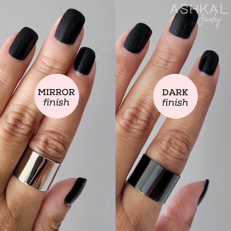 May include: Two silver rings with different finishes. The ring on the left has a mirror finish and the ring on the right has a dark finish. Both rings are on a person's finger.