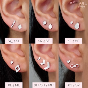 May include: Six different pairs of silver earrings, each pair featuring a unique design. The earrings are displayed on a model's earlobes. The designs include a row of small circles, a diamond, a flower, a teardrop, a small circle, a larger teardrop, a diamond, a chevron, a heart, and an infinity symbol.