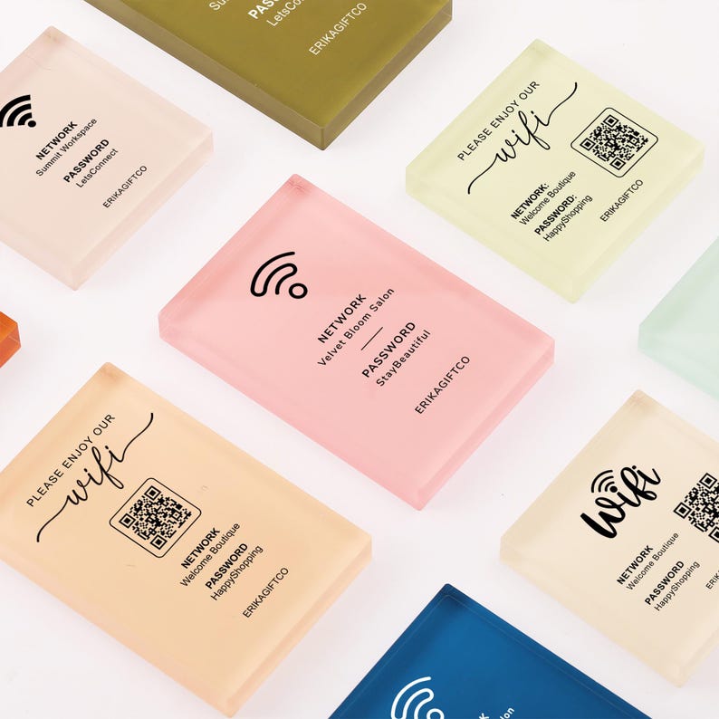 May include: A collection of rectangular acrylic signs in various pastel colors, each featuring printed black text for Wi-Fi network names, passwords, and QR codes. The signs include the brand name ERIKAGIFTCO and icons for wireless internet connectivity.