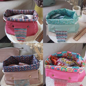 May include: Four colorful knitting project bags. Each bag has a different exterior color, including pink, green, and tan. The interiors feature patterned fabric, and each bag has a small knitted swatch attached to the front.