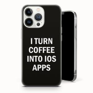 May include: Black iPhone case with the text "I TURN COFFEE INTO IOS APPS" in white. The phone case has a clear border and a triple-lens camera system. The phone screen is black.