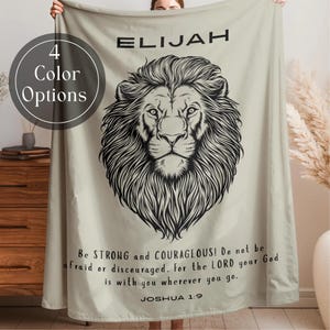 May include: A white ceramic mug with a black handle and the text "But First, Coffee" in a bold, black font. The mug is set against a blurred background, suggesting a cozy setting.