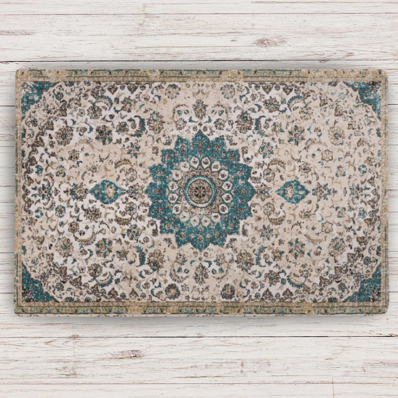 Gifts for Cat Lover Rectangular rug with an ornate floral design in cream, teal, and brown. The rug features a central teal medallion and a border with a similar colour scheme. The pattern is detailed and intricate, suitable for home decor.