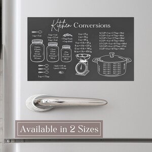 May include: A rectangular dark gray kitchen conversion magnet featuring white line art illustrations of jars, a scale, and a pot. The text reads Kitchen Conversions and provides various volume, weight, and temperature measurement equivalents for cooking.