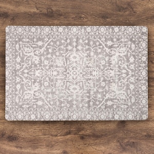 A rectangular, Grey Rug Dog Mat for Food Bowls  with a detailed, white, vintage-style pattern. The design features floral and geometric elements, creating a classic rug appearance. The placemat is set against a wooden surface.