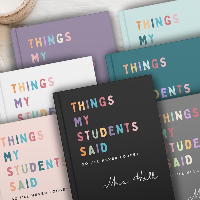 A selection of custom teacher gifts notebooks in shades like black, purple, and teal. Each notebook displays the text "THINGS MY STUDENTS SAID" in colourful lettering. These notebooks are designed for teachers to record student quotes.