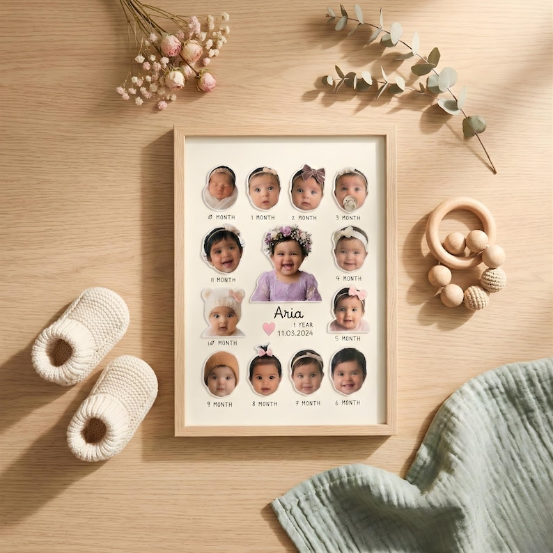 May include: A framed baby photo collage with a light wood frame. The collage features photos of a baby girl at different ages, with the name "Aria" and the date "11.03.2024" displayed.  Also shown are a pair of white baby booties and a wooden toy.