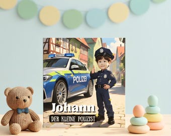 May include: A children's book cover featuring a cartoon illustration of a young boy dressed as a police officer, giving a thumbs-up. A police car is in the background. The book title is "Johann Der Kleine Polizist."