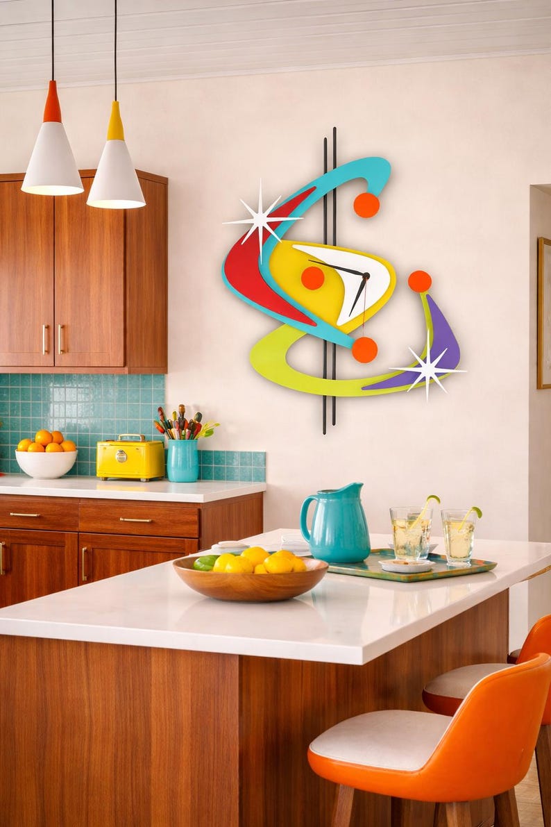 May include: A vibrant, retro-style wall clock with a starburst design. The clock has a yellow face, red and blue details, and black hands. It's mounted on a white wall in a kitchen. The kitchen has wooden cabinets.