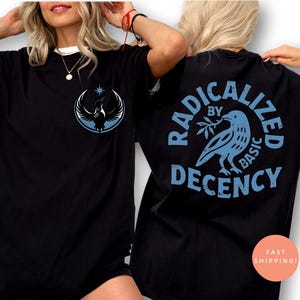 May include: Black t-shirts with a graphic design. One shirt features a bird and star emblem on the front. The other shirt has the words "RADICALIZED BY BASIC DECENCY" surrounding a bird holding a branch.
