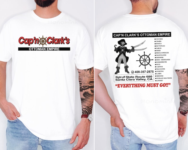 Peut inclure: Un t-shirt blanc &agrave; manches courtes avec un graphisme frontal portant le texte rouge Cap'n Clark's et une barre de navire. Le dos pr&eacute;sente une illustration de pirate, le texte Cap'n Clark's Ottoman Empire, une liste de meubles et Everything Must Go.