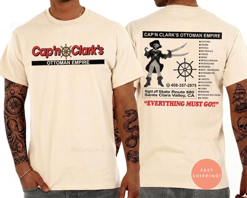 Peut inclure: Un t-shirt couleur cr&egrave;me avec un graphisme sur le devant indiquant Cap'n Clark's Ottoman Empire. Le dos pr&eacute;sente une illustration de pirate, une barre de navire, une liste de meubles, le texte 408-357-2875 et Everything Must Go.