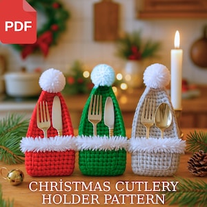 May include: Three crocheted Christmas cutlery holders in red, green, and grey, shaped like Santa hats with white pom-poms and trim. Gold forks and knives or spoons are inside. The text "CHRISTMAS CUTLERY HOLDER PATTERN" is at the bottom.