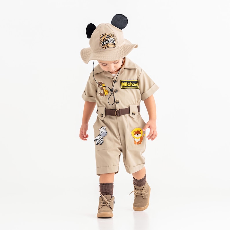 a little boy dressed in a safari animal costume