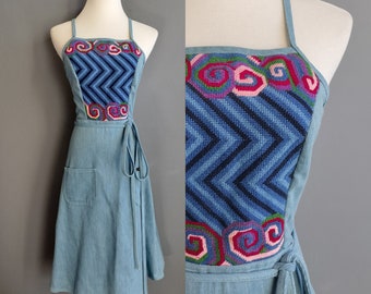 1970s needlepoint embroidery bib overall dress, denim pinafore sundress with hand embroidered bodice, lace up back wrap dress, slantzi craft