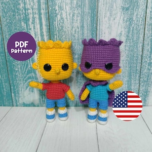 May include: Two crocheted dolls, one in yellow with a red shirt and blue shorts, the other in purple with a blue shirt and shorts. Both dolls have black eyes and are standing. The image includes a PDF pattern label and an American flag.