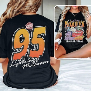 May include: Black t-shirt with a large orange and yellow number 95 graphic and "Lightning McQueen" text. The shirt also has a small "Rusteze" logo. A second image shows a black t-shirt with a "Lightning McQueen" Halloween design and the words "Trick or Treat".