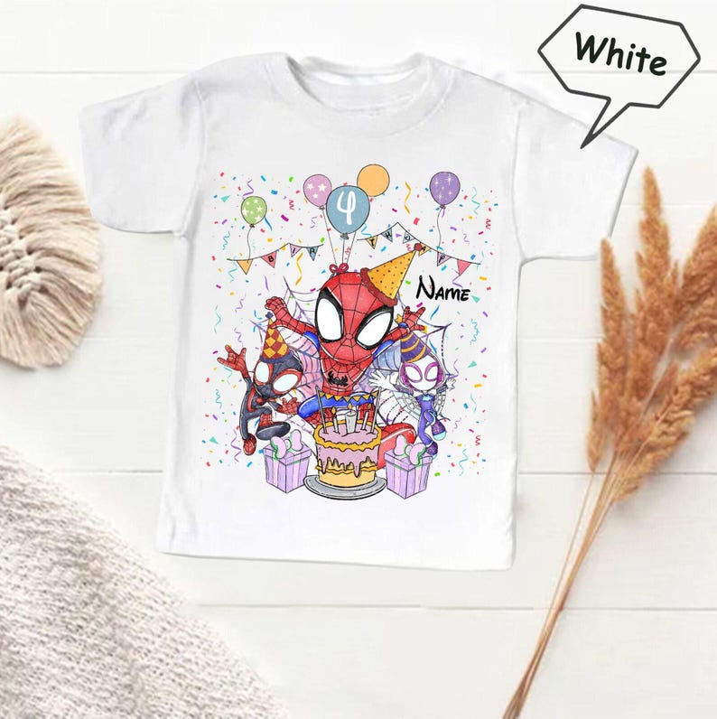 May include: White t-shirt featuring a colorful illustration of Spider-Man celebrating a birthday. The design includes balloons, confetti, a cake, and the number 4. The word "Name" is also visible.