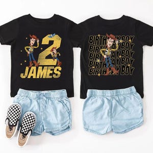 May include: Two black t-shirts with Woody from Toy Story graphics, paired with light blue denim shorts and checkered slip-on shoes. One shirt says "2 JAMES" and the other says "BIRTHDAY BOY".