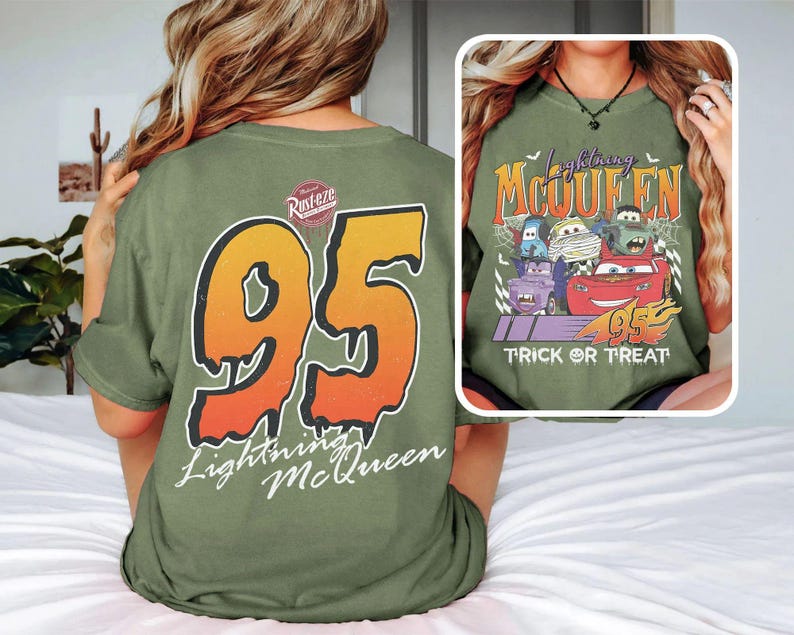 May include: Olive green t-shirt with a large orange and yellow number 95 and "Lightning McQueen" on the back. The front displays a graphic of Lightning McQueen and other Cars characters with the text "Trick or Treat".
