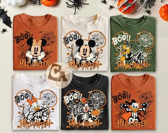 May include: Six Halloween-themed t-shirts in various colors, featuring Disney characters like Mickey, Minnie, and Donald Duck. Each shirt has a "BOO!!" graphic and "HALLOWEEN" text, with spiderwebs and spooky illustrations.