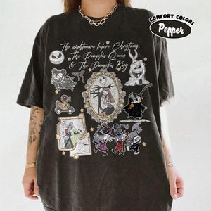 May include: Black t-shirt with a graphic featuring characters and text from "The Nightmare Before Christmas." The design includes Jack Skellington, Sally, and other characters in a vintage style. The shirt is labeled "Comfort Colors Pepper."