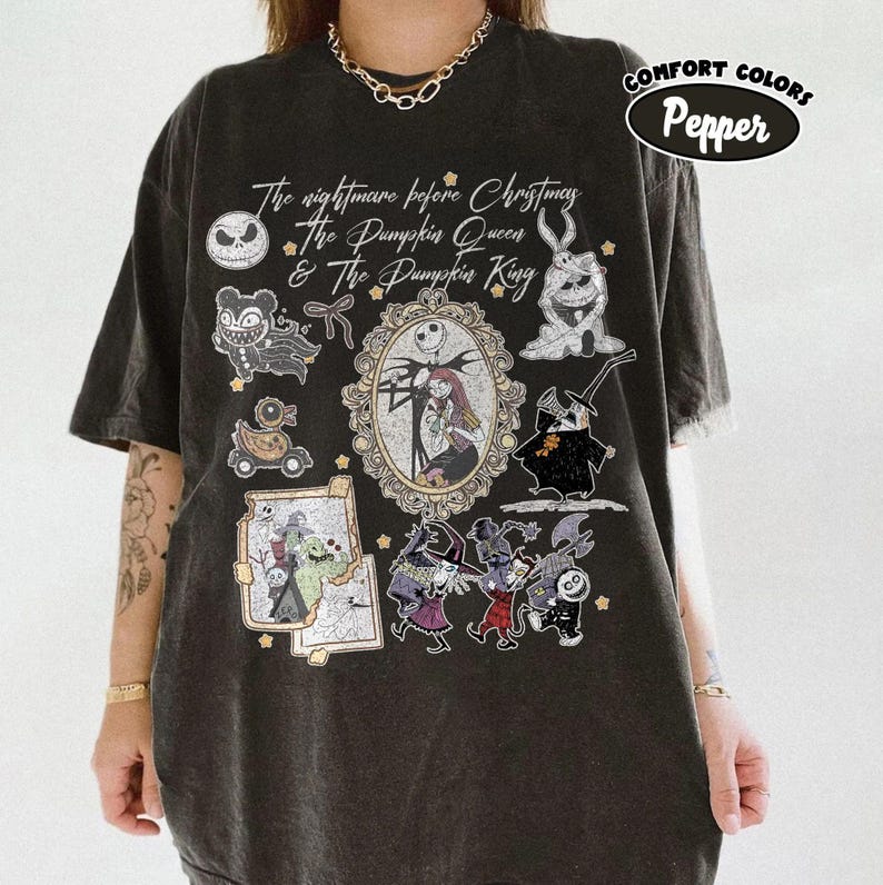 May include: Black t-shirt with a graphic featuring characters and text from "The Nightmare Before Christmas." The design includes Jack Skellington, Sally, and other characters in a vintage style. The shirt is labeled "Comfort Colors Pepper."