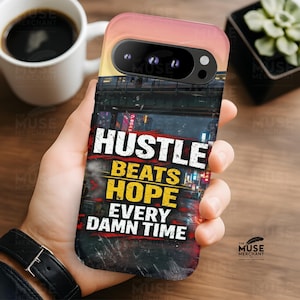 May include: A phone case with a cityscape design and the text "HUSTLE BEATS HOPE EVERY DAMN TIME." The case has a gradient of colors, transitioning from pink to yellow. The phone case is held in a hand.