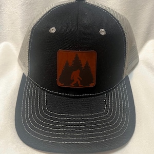 Structured Mesh SnapBack Bigfoot Leather Patch Hat – Distressed Black Trucker Cap, Sasquatch Forest Design