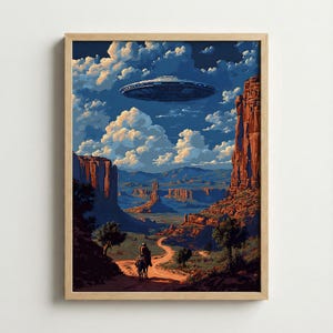 May include: A framed art print depicting a desert landscape with a UFO hovering in the sky. The artwork features a rider on horseback on a dirt road, with red rock formations and a cloudy blue sky. The print is in a wooden frame.