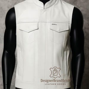 May include: White leather vest with a stand-up collar and two front pockets. The vest has a tailored fit and a minimalist design. The brand name "DesignerBrandReh99" and "LEATHER GOODS" are printed on the lower right side of the vest.