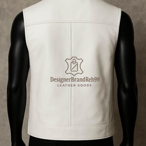 May include: A white leather vest with a tailored fit, featuring a collared neckline and vertical stitching details. The vest has a logo that reads "DesignerBrandReh99 LEATHER GOODS". The vest is displayed on a mannequin.