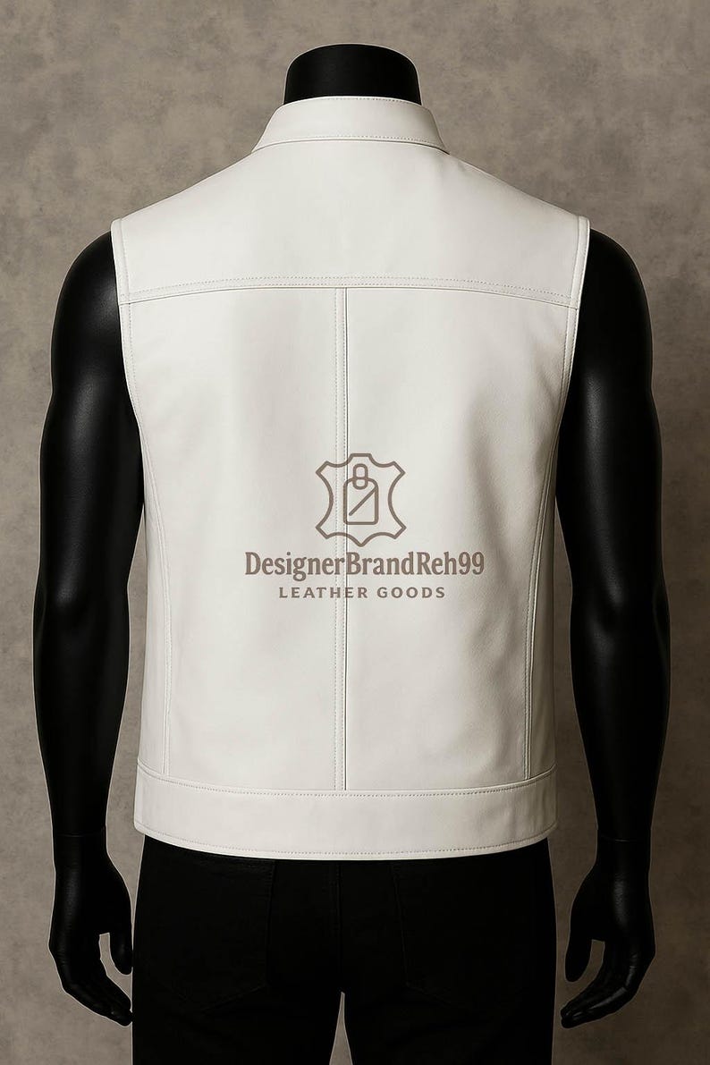 May include: A white leather vest with a tailored fit, featuring a collared neckline and vertical stitching details. The vest has a logo that reads "DesignerBrandReh99 LEATHER GOODS". The vest is displayed on a mannequin.