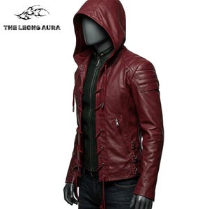 May include: A burgundy leather jacket with a hood, displayed on a mannequin. The jacket features a zip-up front, lace-up detailing, and a quilted shoulder design. The Leons Aura logo is visible in the upper left corner.