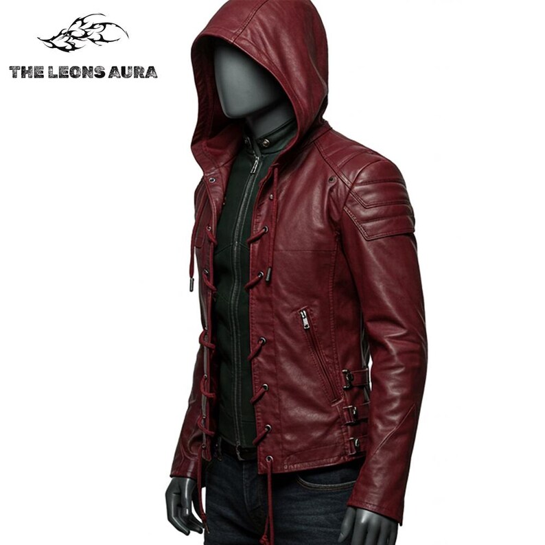 May include: A burgundy leather jacket with a hood, displayed on a mannequin. The jacket features a zip-up front, lace-up detailing, and a quilted shoulder design. The Leons Aura logo is visible in the upper left corner.
