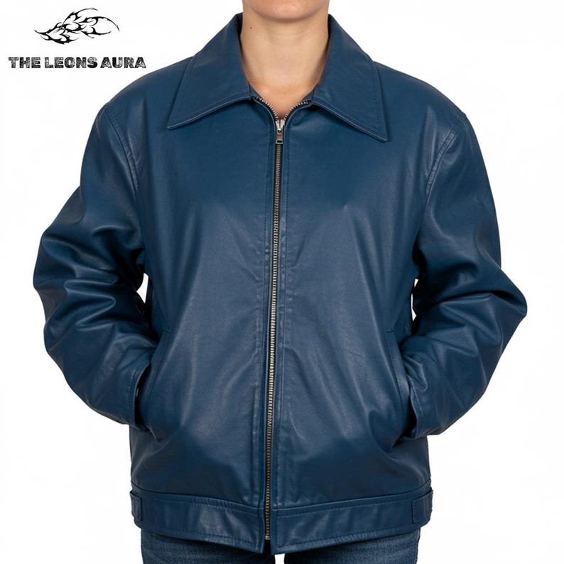 May include: A dark teal leather jacket with a zipper closure and a collared neckline. The jacket has two front pockets and the text "THE LEONS AURA" at the top left.