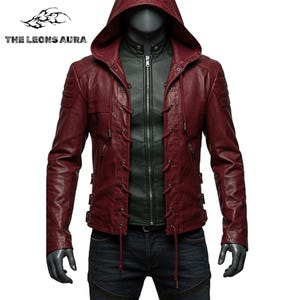 May include: Burgundy leather jacket with a hood and lace-up details. The jacket has a zipper closure and a dark green inner layer. The text "THE LEONS AURA" is visible in the upper left corner. The jacket is displayed on a mannequin.