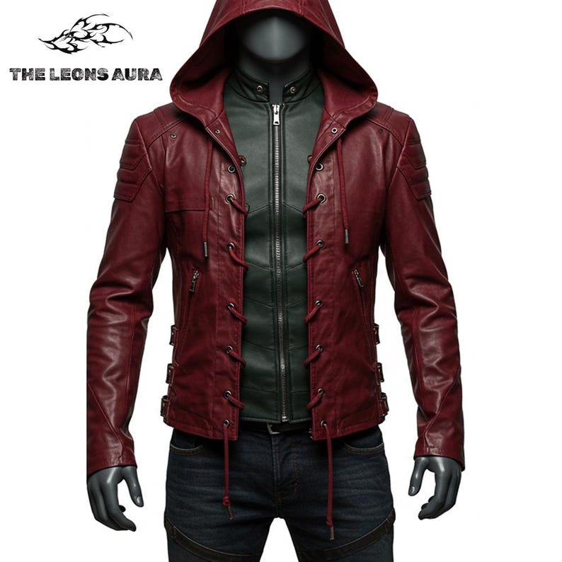 May include: Burgundy leather jacket with a hood and lace-up details. The jacket has a zipper closure and a dark green inner layer. The text "THE LEONS AURA" is visible in the upper left corner. The jacket is displayed on a mannequin.
