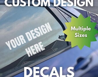 May include: A blue car window with white text that reads "CUSTOM DESIGN", "YOUR DESIGN HERE", and "DECALS". A green starburst graphic indicates "Multiple Sizes". The window reflects a cloudy sky.