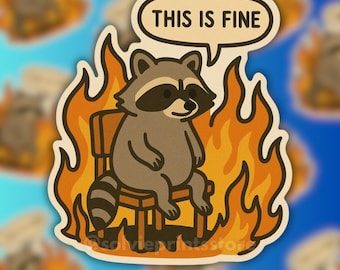 May include: A sticker featuring a cartoon raccoon sitting calmly in a chair surrounded by flames. The raccoon has a black mask and is smiling. A speech bubble above the raccoon reads "THIS IS FINE". The sticker has a white border and a blue background.