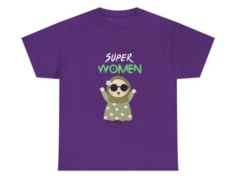May include: A purple t-shirt featuring the text "SUPER WOMEN" in white and green. Below the text is a cartoon illustration of a woman wearing a hijab, sunglasses, and a floral dress. The t-shirt is made of a soft, comfortable material.