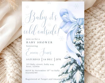 May include: A rectangular baby shower invitation card featuring the text Baby it's cold outside! Join us for a BABY SHOWER honouring Emma Jones. The design includes a watercolor illustration of a snow-covered pine tree with a large light blue bow.