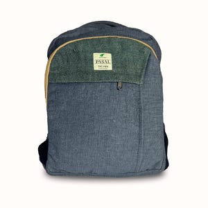 May include: A blue backpack made from textured fabric. The top section is a darker green with a tan trim. The backpack has a zipped pocket and a label that reads "PASAL THC FREE".